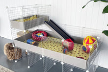 Load image into Gallery viewer, A grey Ozzy Cages C&C Guinea Pig enclosure with 2x1 loft filled with HayPigs! circus accessories. Lifestyle image.