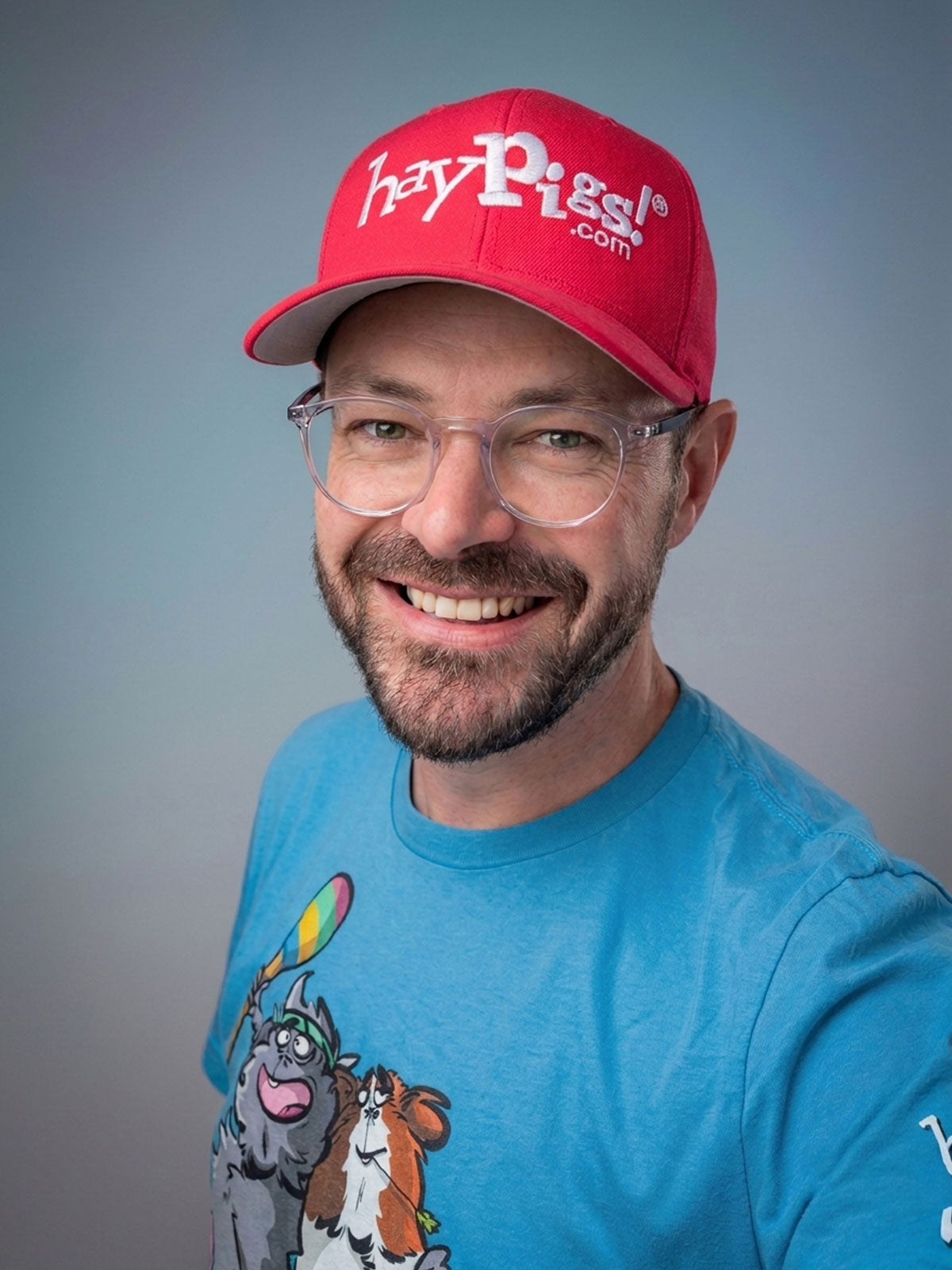 Rik Cridland, co-founder of HayPigs!, wearing a HayPigs! cap and T-shirt